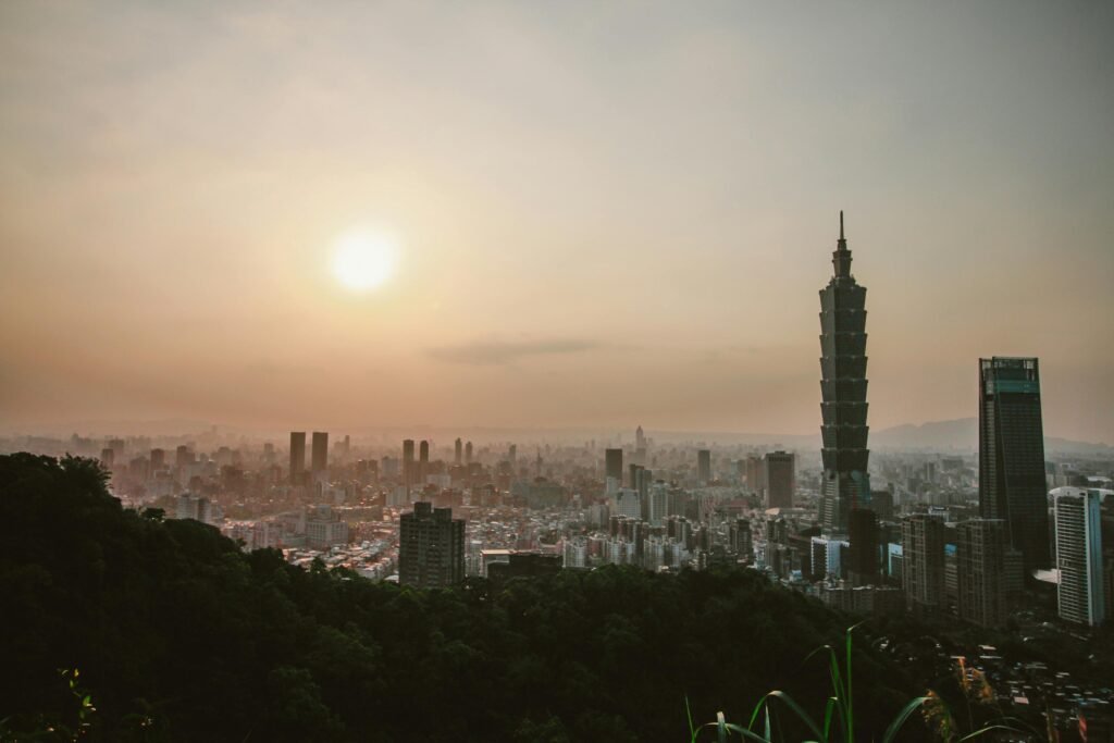 Skyline of Taipei featuring Taipei 101 during sunset with a dramatic urban cityscape.